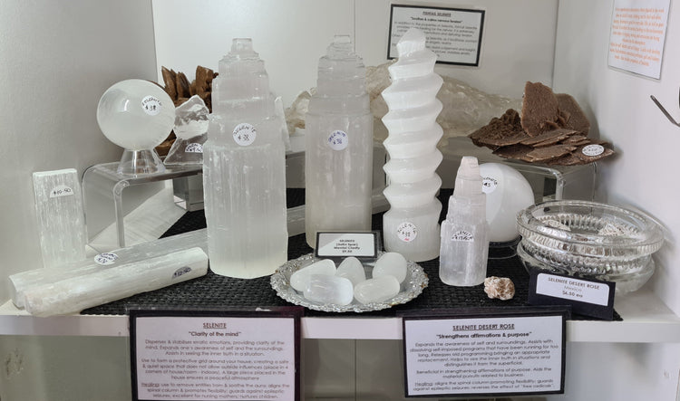 A range of selenite carvings in display shelf