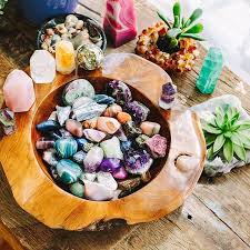 Timber bowl containing crystals set on an altar with plants and crystals surrounding