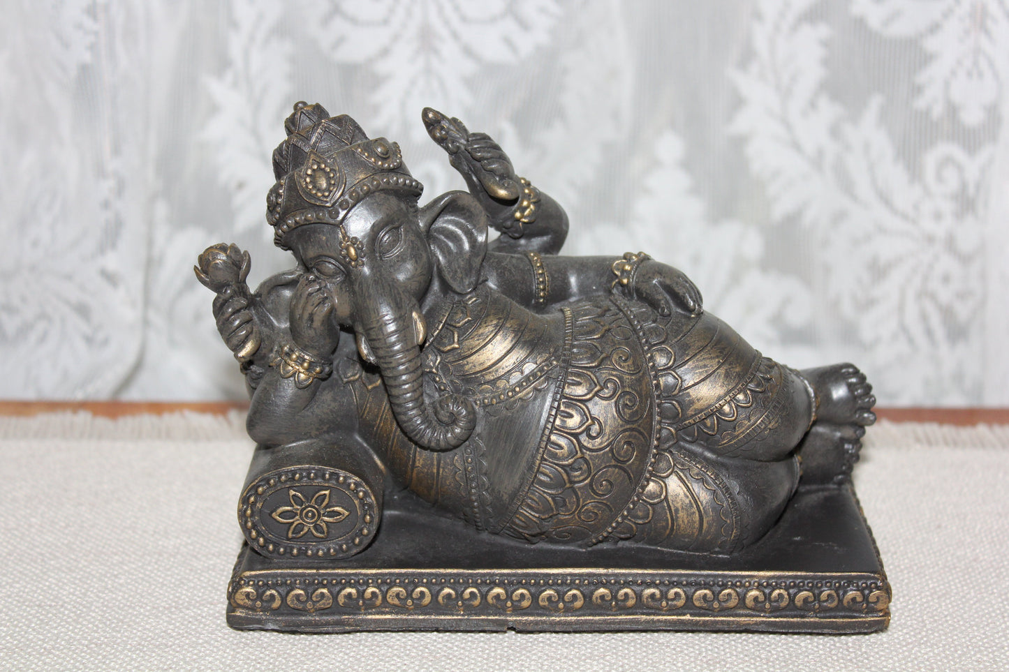 Ganesha - resting on cushion - bronze look