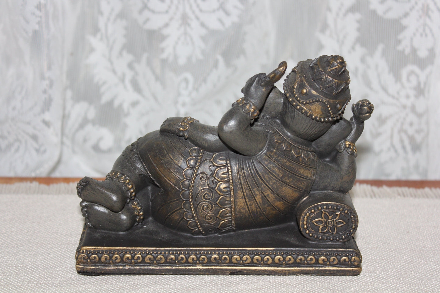 Ganesha - resting on cushion - bronze look
