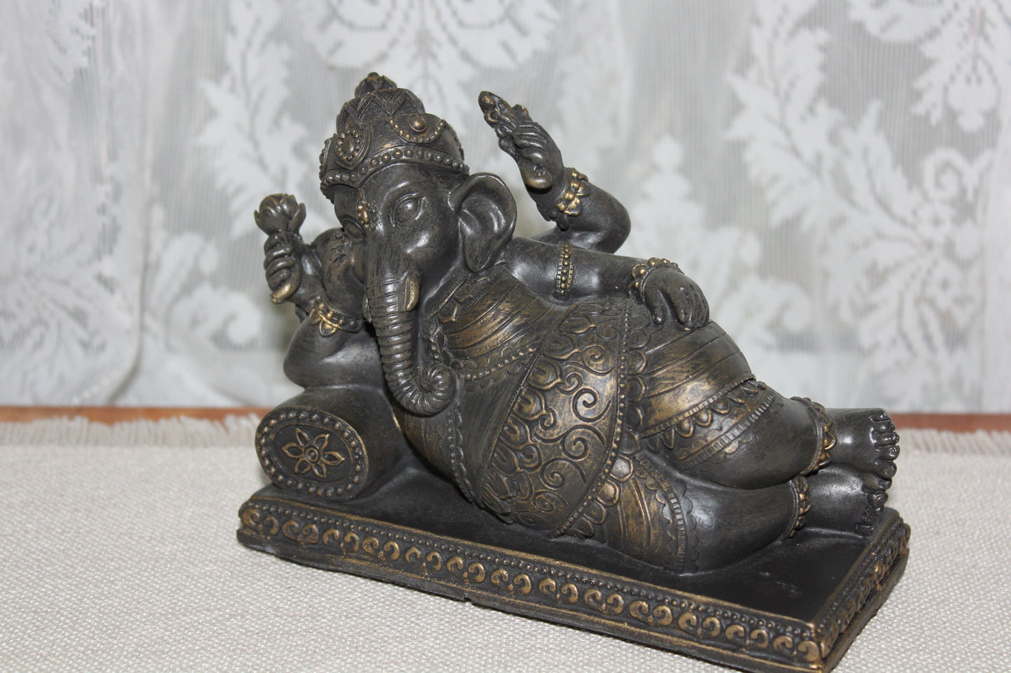 Ganesha - resting on cushion - bronze look