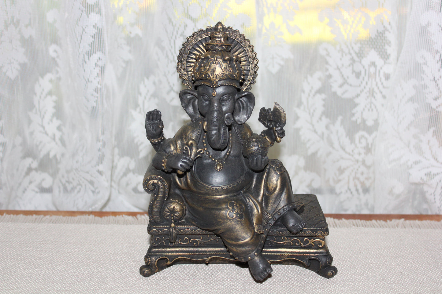 Ganesha - sitting on lounge - bronze look
