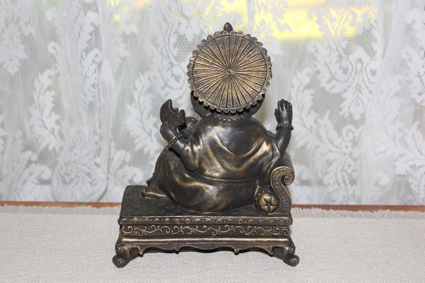 Ganesha - sitting on lounge - bronze look