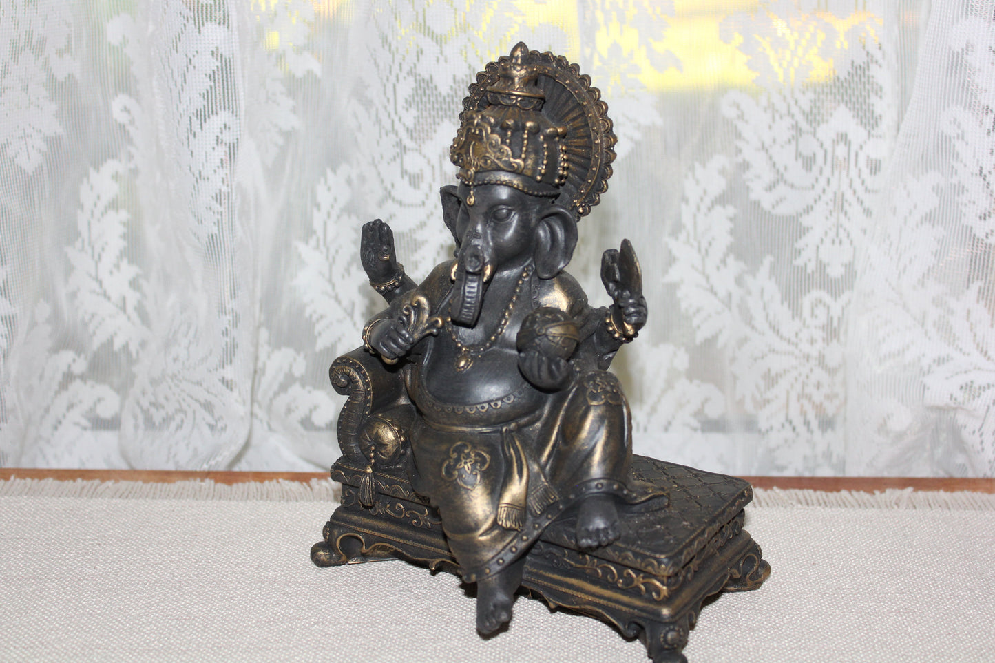 Ganesha - sitting on lounge - bronze look