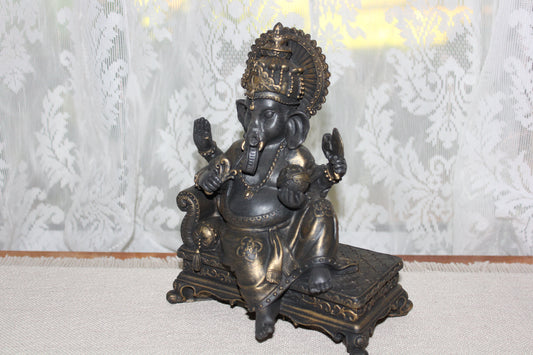 Ganesha - sitting on lounge - bronze look